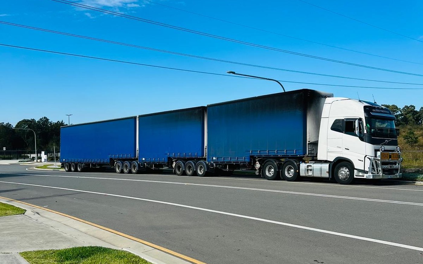 A JBM Logistics curtainsider B-double on the Nullarbor